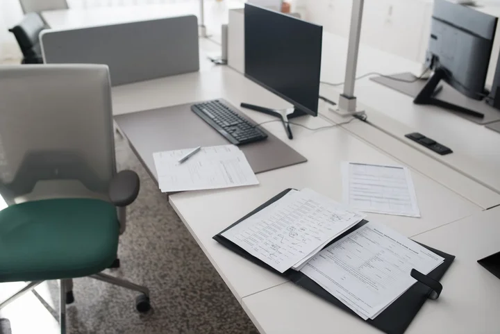 An open document folder and supporting records arranged on a desk.